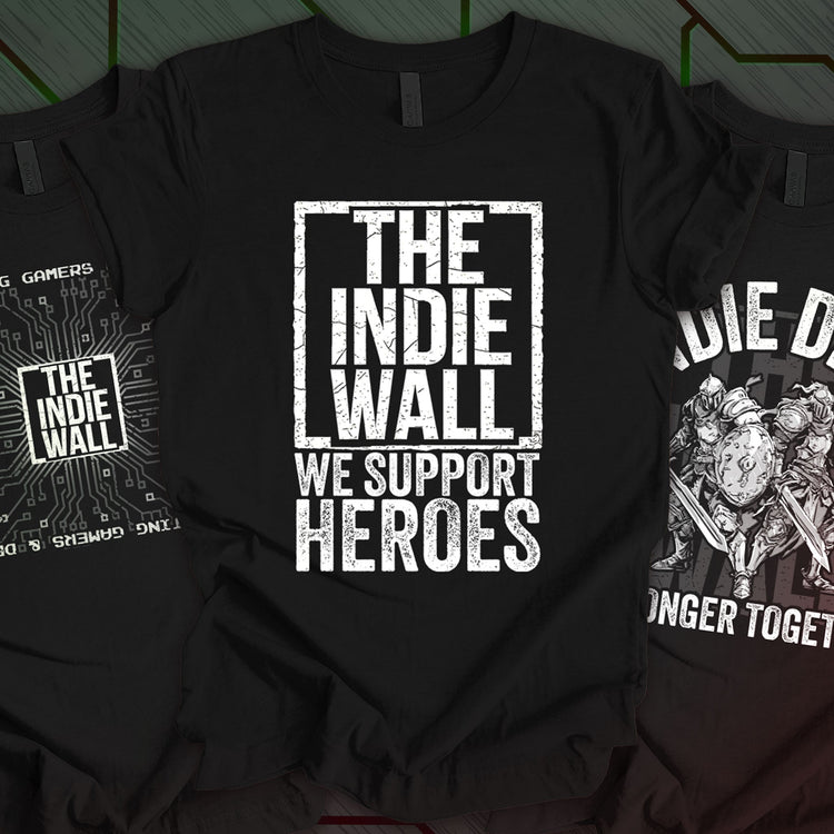 Three black t-shirts featuring The Indie Wall branding and supportive messages: "We Support Heroes," "Uniting Gamers and Devs," and "Indie Devs Stronger Together." Perfect for fans of indie games and creator culture.