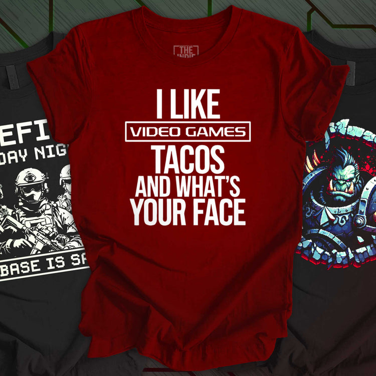 Three black gamer-themed t-shirts with pixel art designs, including "Game Over and Over" in green retro text, a fire-breathing demon goat, and a military-style Friday Night Ops shirt. Perfect for gamers and indie game fans.