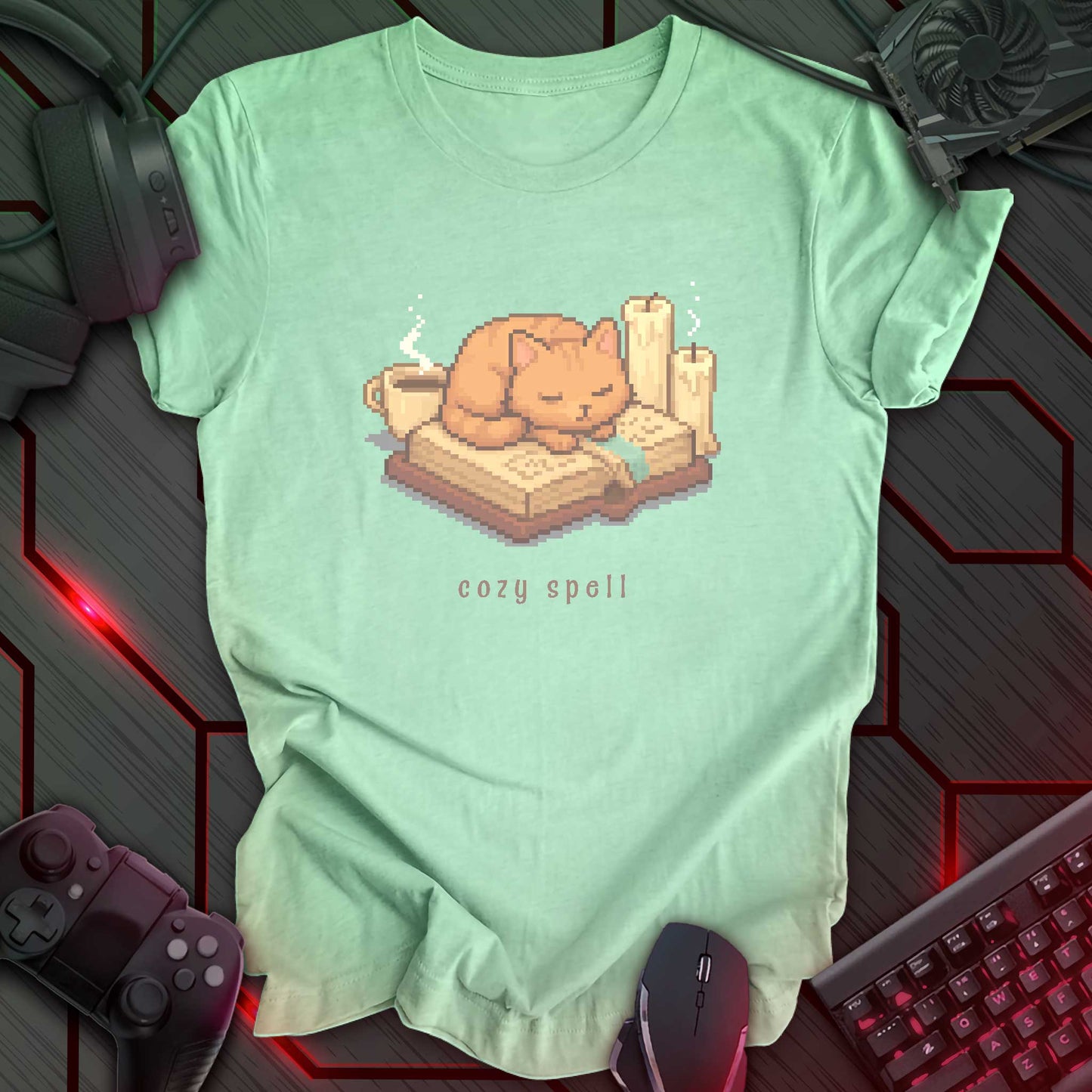 Pixel art orange cat sleeping on a book with candles and a coffee mug, under the text "cozy spell" in soft cozy gamer style. Heather Mint background.