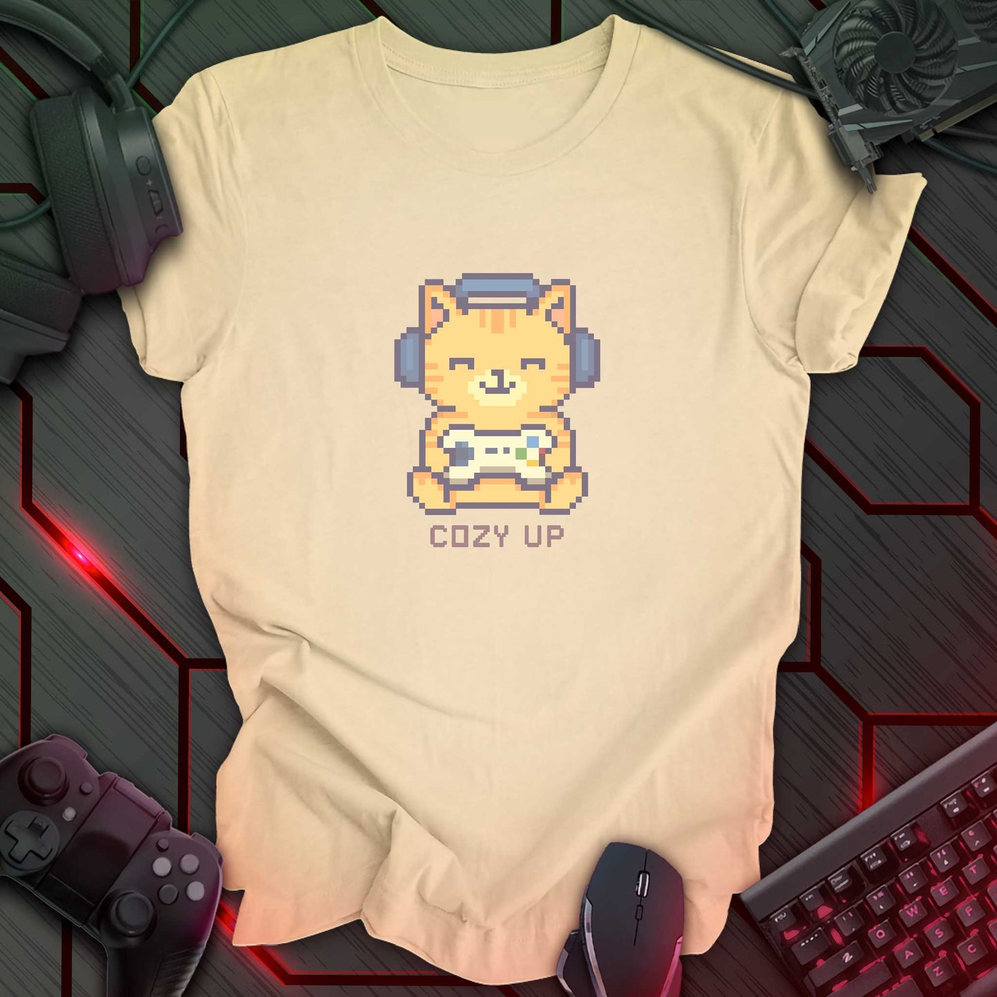 Pixel art orange cat wearing headphones and holding a game controller above the words "Cozy Up" in cozy gamer kawaii style. Soft Cream background.