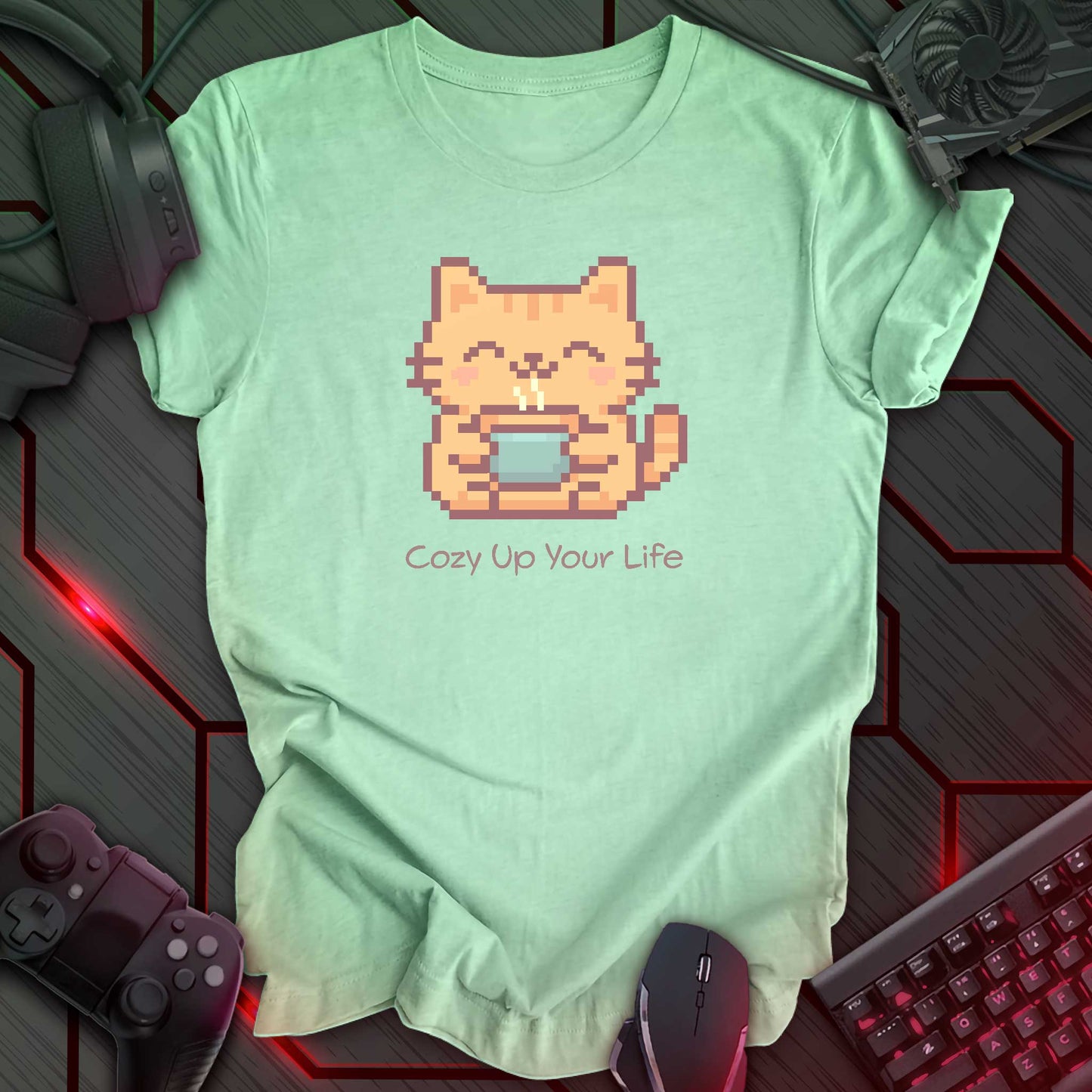 Pixel art orange cat holding a cup of hot tea with a happy expression on the cat's face. Print on a mint green t-shirt.