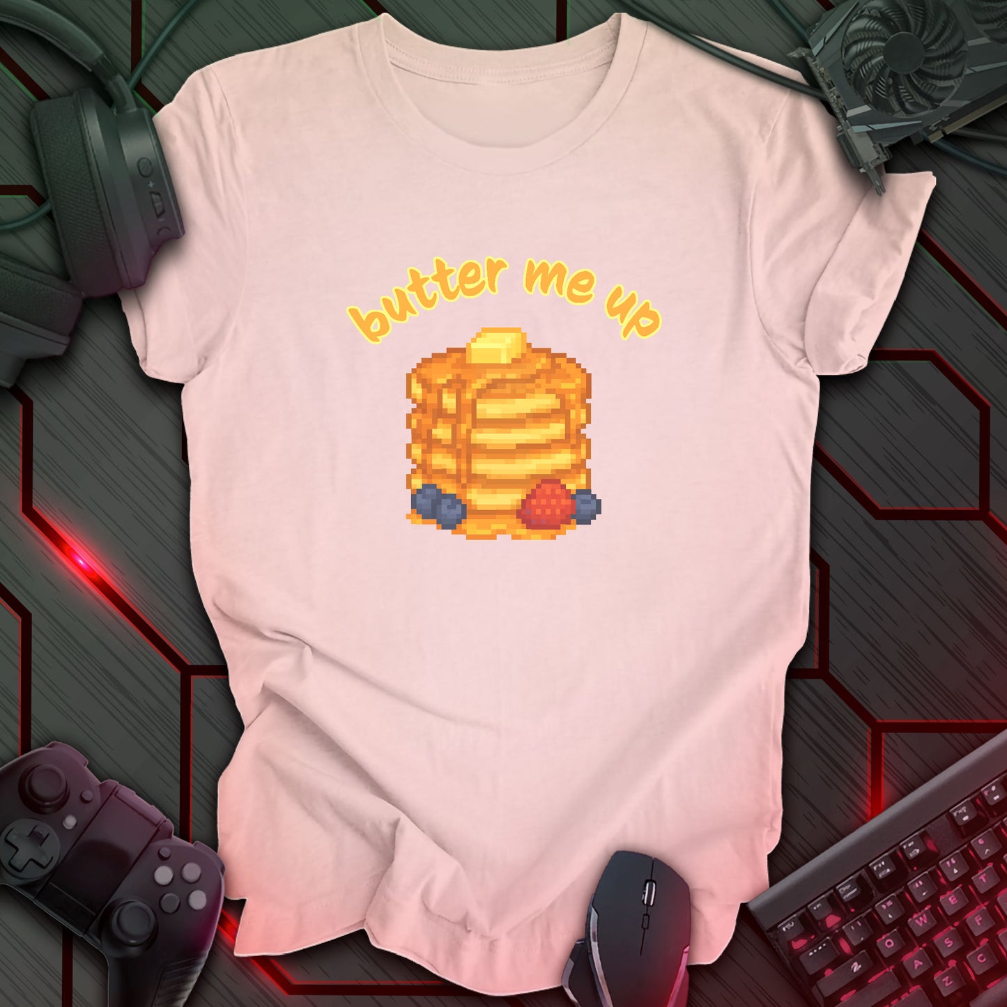 Pixel art stack of pancakes topped with butter and syrup, surrounded by blueberries and a strawberry, with text "butter me up" in kawaii style. Soft Pink background.