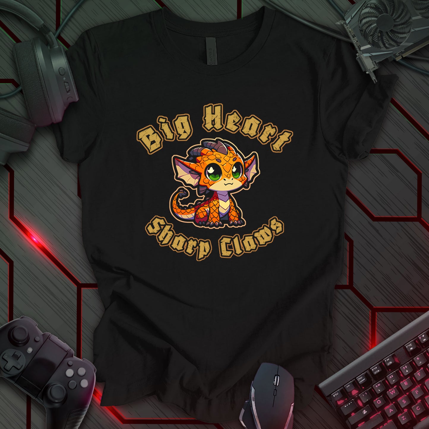Black T-shirt featuring bold medieval-style text that reads 'Big Heart Sharp Claws' above and below a cute Kawaii-style baby dragon illustration. The dragon has a large head, big green eyes, swept-back horns, large dragon ears, orange scales, tiny sharp claws, a long tail with small spikes, and a playful expression. Perfect for fantasy and dragon lovers