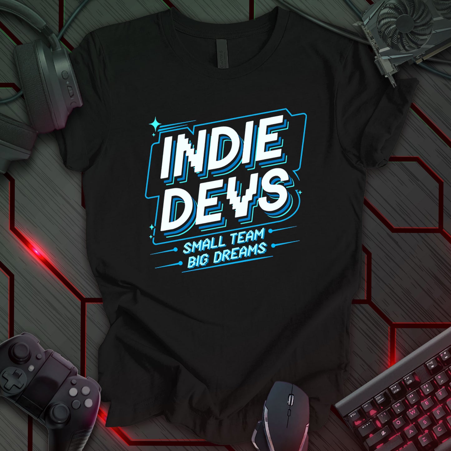 T-shirt design with "INDIE DEVS" in bold, stylized white text with blue outline on a black background. Includes "SMALL TEAM - BIG DREAMS -" in pixelated font below. Design celebrates indie game developers and their passion. Keywords: indie dev shirt, game developer tee, pixel art design, indie gaming apparel, coding t-shirt, programmer gift, video game design, techie clothing.
