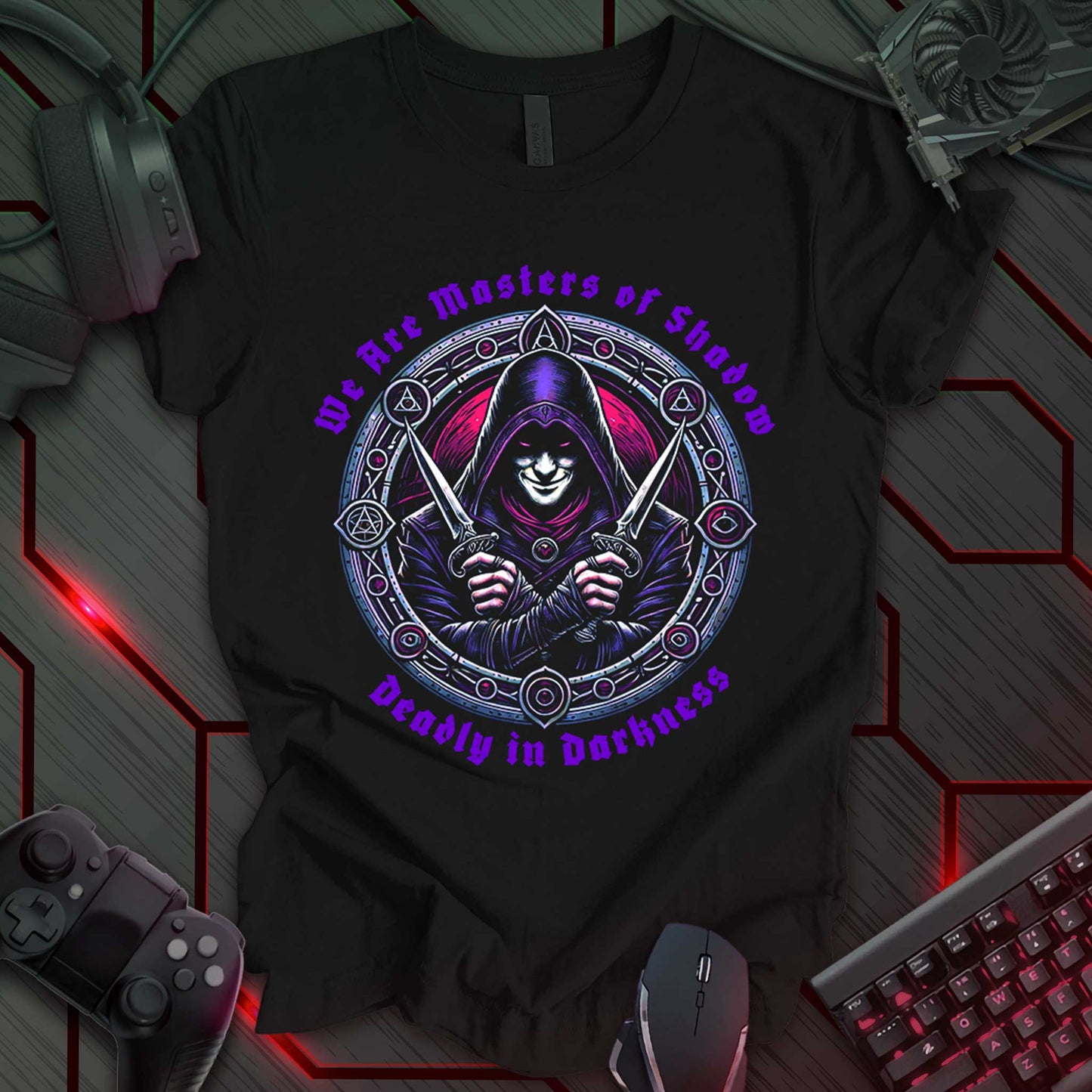 Black gaming t-shirt featuring a hooded assassin wielding dual daggers, surrounded by a circular frame with arcane symbols. The design has deep red and purple tones, with fantasy-style text reading 'We Are Masters of Shadow – Deadly in Darkness.' Perfect for RPG and stealth gaming fans.