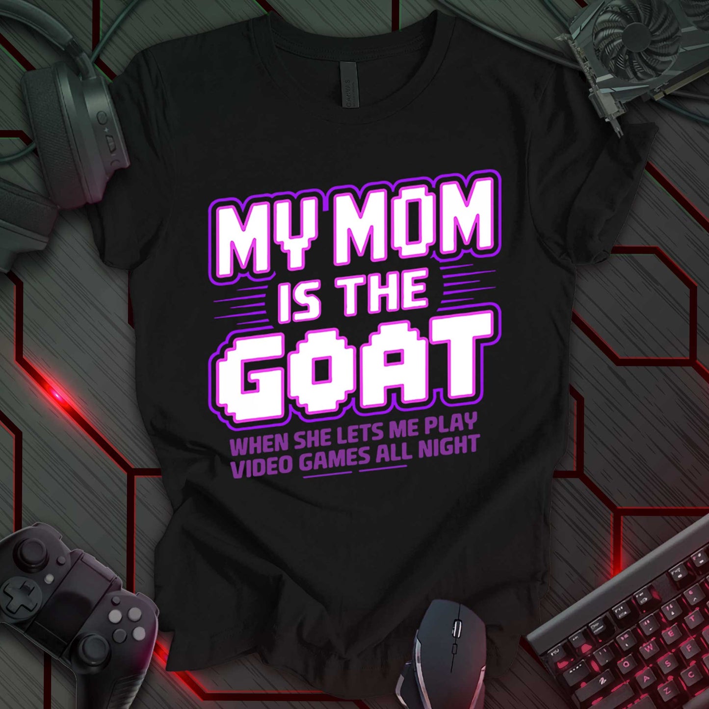 T-shirt design with stylized text "MY MOM IS THE GOAT" in white and purple on a black background. Includes "WHEN SHE LETS ME PLAY VIDEO GAMES ALL NIGHT" below. Humorous and trendy design for kids or teens celebrating their mom's coolness. Keywords: gamer mom shirt, funny kid tee, video game t-shirt, trendy mom gift, cool mom clothing, gaming humor, teen gamer gift, mom appreciation shirt.
