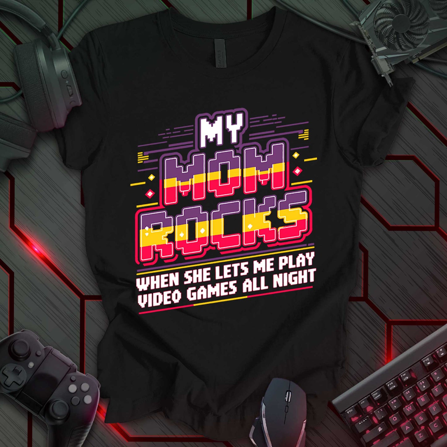 This t-shirt design, targeted at young gamers, features the phrase 'MY MOM ROCKS WHEN SHE LETS ME PLAY VIDEO GAMES ALL NIGHT' in a bold, pixelated font with red, yellow, and black colors. The design includes stylized lines and geometric shapes, appealing to a playful, video game-loving audience.