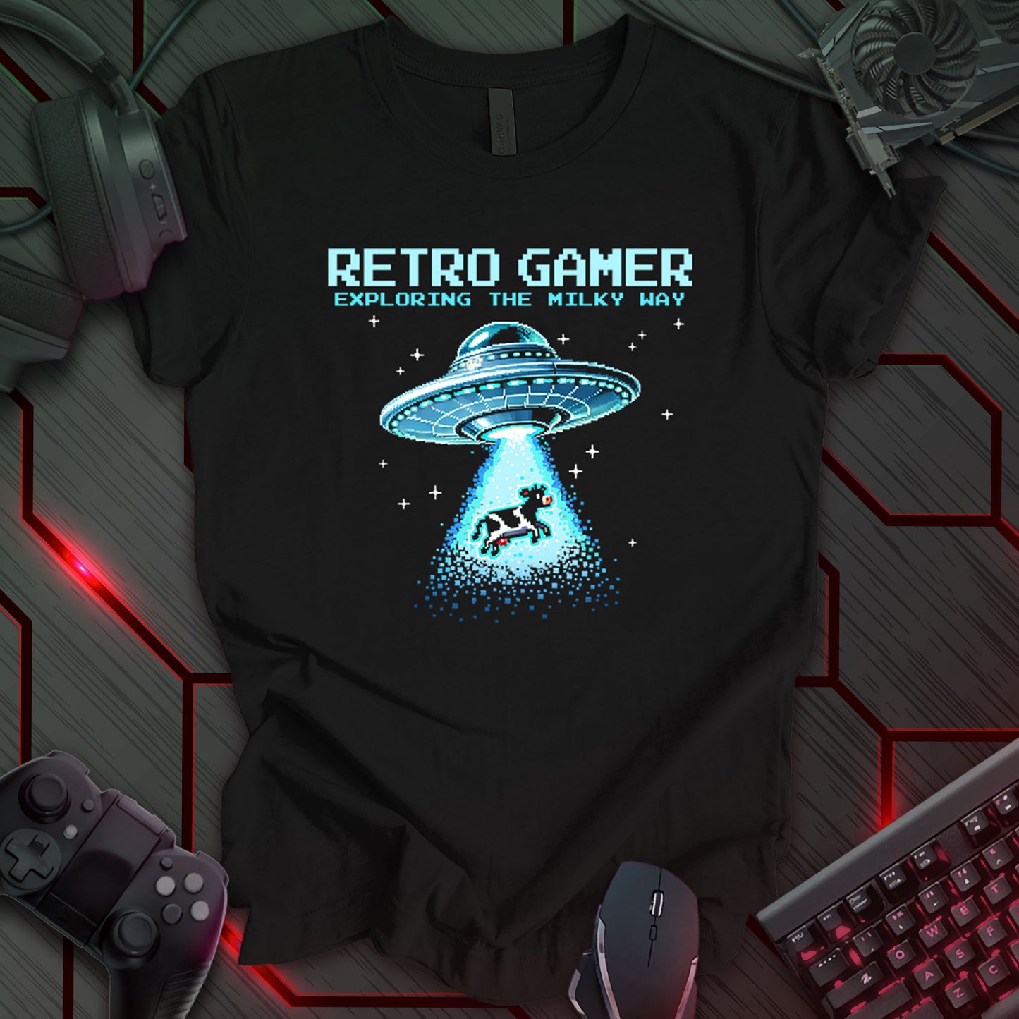 Black T-shirt featuring a light blue pixel-art design of a retro-style flying saucer abducting a cow with its tractor beam in outer space. Above the illustration, 'RETRO GAMER Exploring the Milky Way' is displayed in a pixelated arcade-style font. Perfect for retro gaming fans, sci-fi lovers, and arcade enthusiasts.