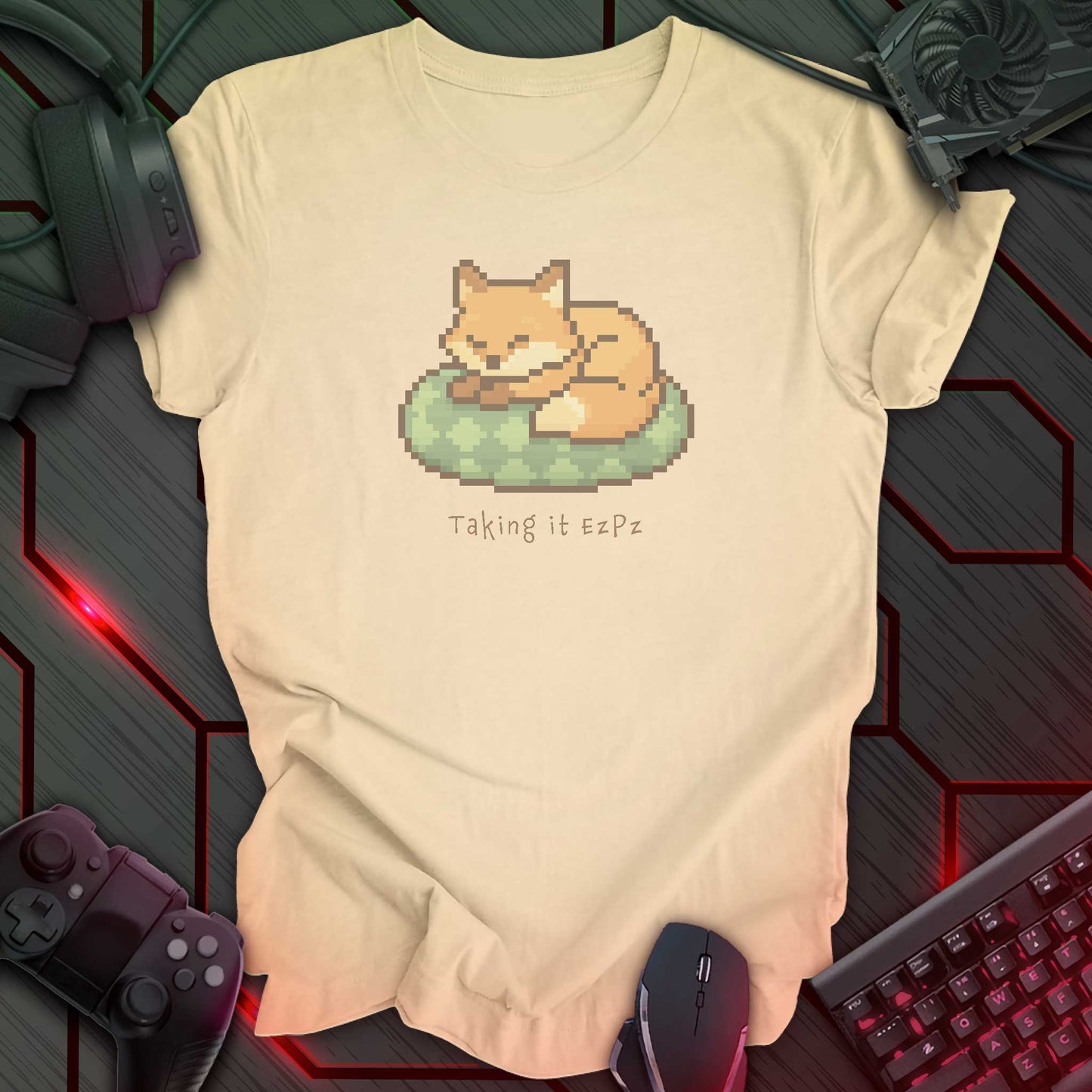Pixel art sleeping fox curled on a green cushion above the phrase "Taking it EzPz" in cozy kawaii gamer style. Soft Cream background.