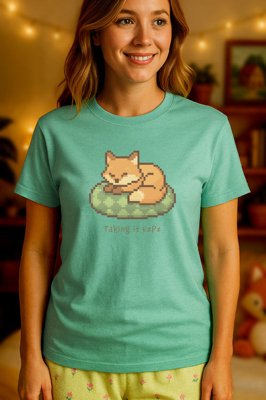 Pixel art sleeping fox curled on a green cushion above the phrase "Taking it EzPz" in cozy kawaii gamer style. Heather Mint background.