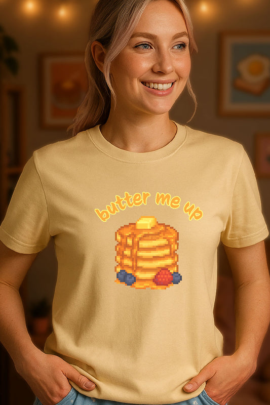 Pixel art stack of pancakes topped with butter and syrup, surrounded by blueberries and a strawberry, with text "butter me up" in kawaii style. Soft Natural background.