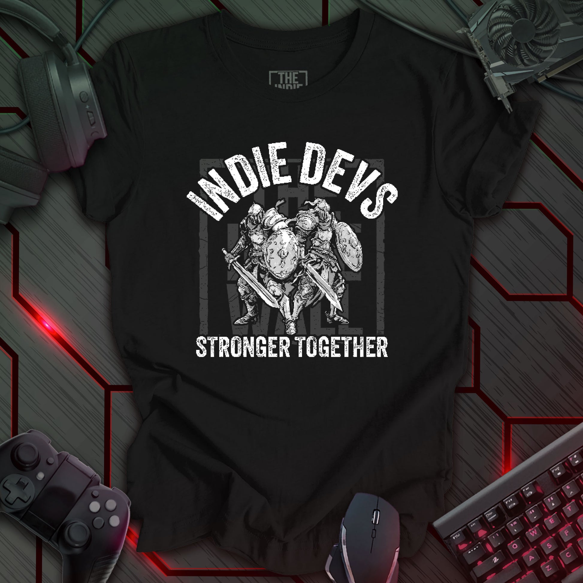 stylized black and white illustration of two armored fantasy warriors standing in front of a large faded Indie Wall brand logo. Bold distressed arched text above reads "INDIE DEVS". Bold text below the image reads "STRONGER TOGETHER". Black background.