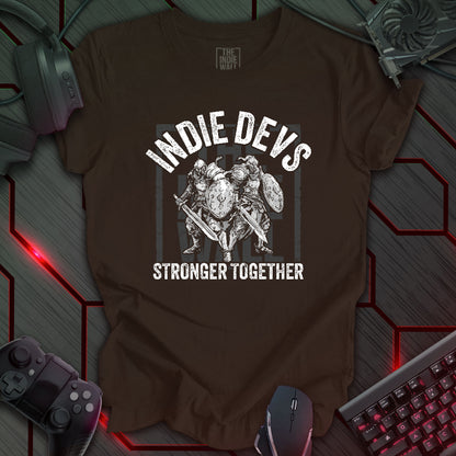 stylized black and white illustration of two armored fantasy warriors standing in front of a large faded Indie Wall brand logo. Bold distressed arched text above reads "INDIE DEVS". Bold text below the image reads "STRONGER TOGETHER". Brown background.
