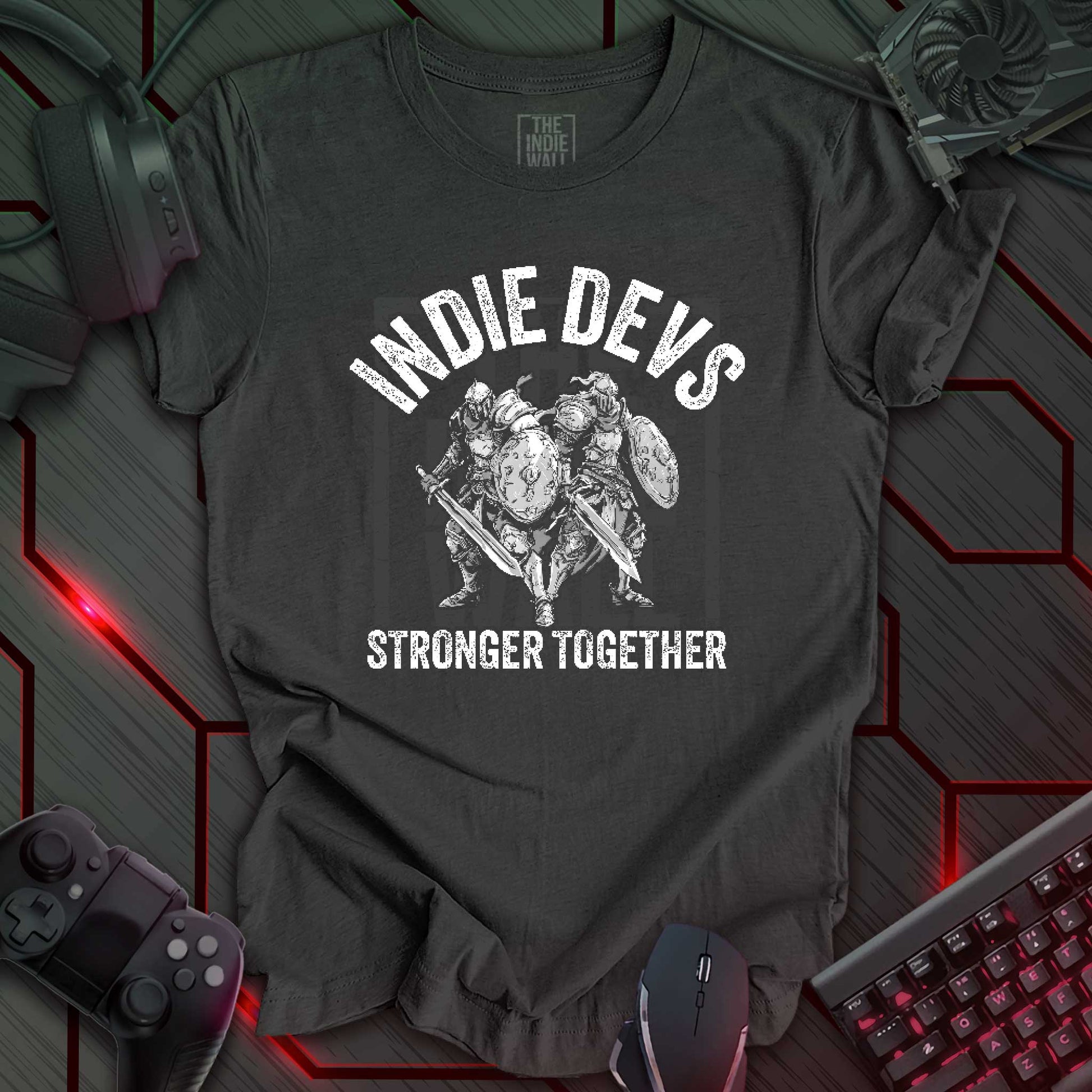 stylized black and white illustration of two armored fantasy warriors standing in front of a large faded Indie Wall brand logo. Bold distressed arched text above reads "INDIE DEVS". Bold text below the image reads "STRONGER TOGETHER". Dark heather grey background.