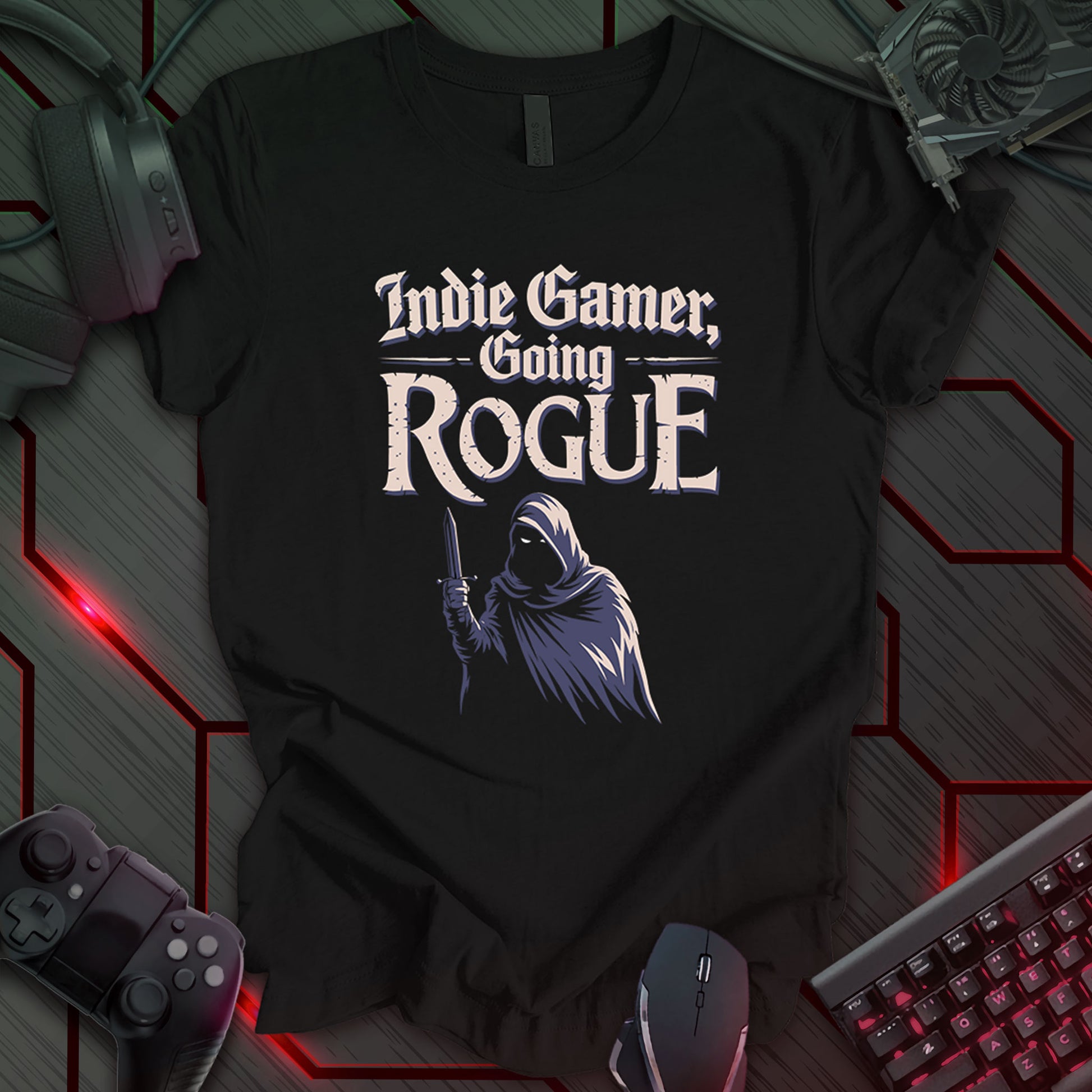 Illustration of a cloaked figure holding a dagger, rendered in shades of gray and beige, against a black background. Above the figure are the words 'Indie Gamer, Going Rogue' in a stylized font. This is a design for indie gamers, featuring a rogue character motif.