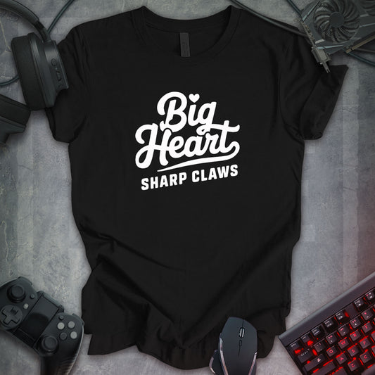 Black gaming t-shirt featuring bold white cursive text reading 'Big Heart Sharp Claws,' designed with a clean, modern typographic style.