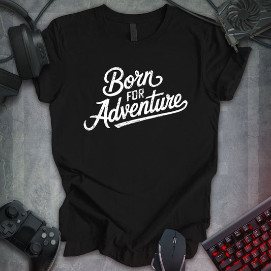 Black gaming t-shirt with vintage-style distressed white cursive text reading 'Born For Adventure,' designed for adventure enthusiasts and gamers.