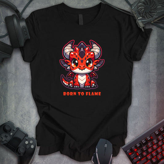 Black gaming t-shirt featuring a Kawaii-style red baby dragon with large eyes, horns, and a playful design. Below the dragon, bold red text reads 'Born To Flame' for a dynamic and fun look.