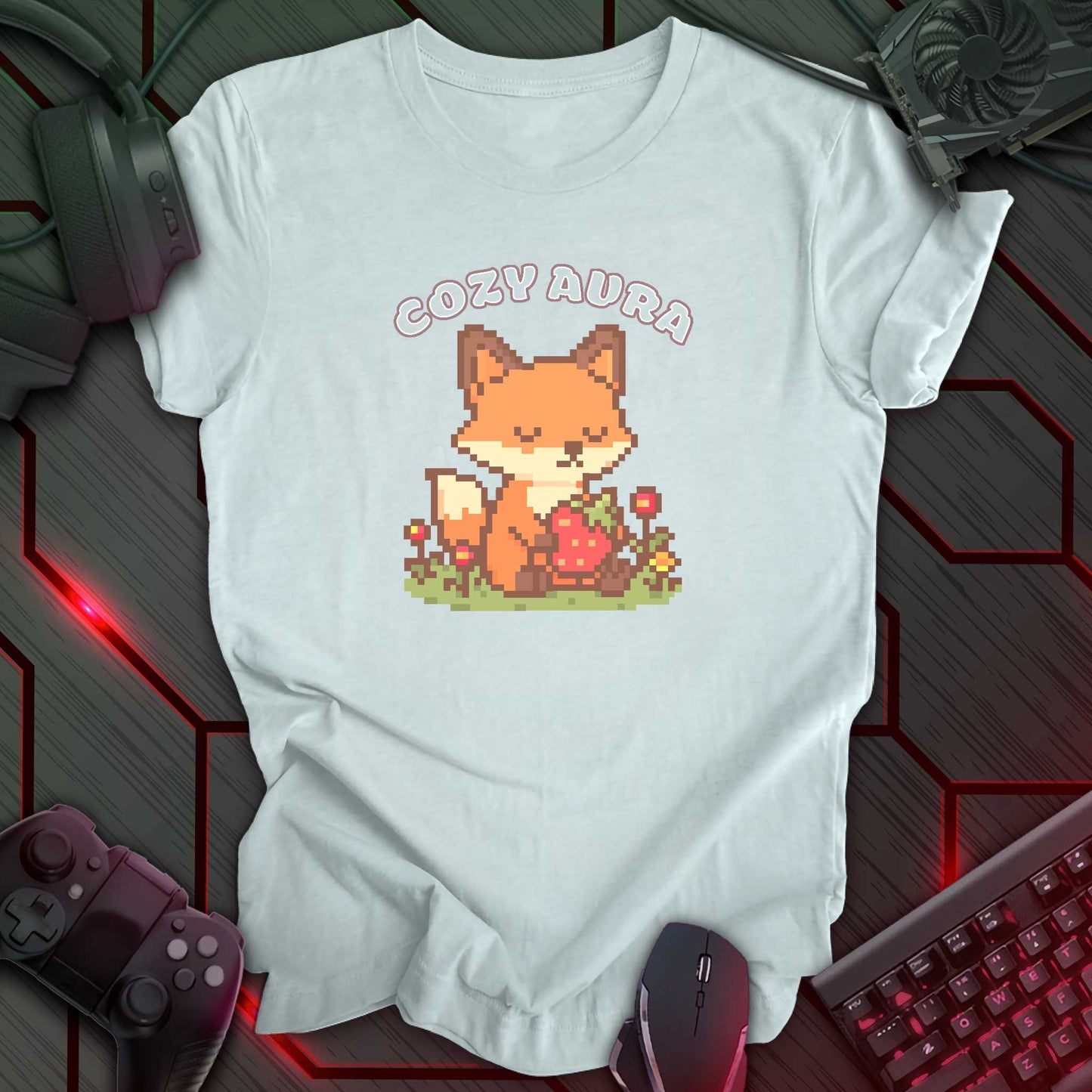Pixel art fox holding a strawberry with closed eyes, surrounded by flowers and text "Cozy Aura" above, in kawaii cozy gamer style. Ice blue color t-shirt.
