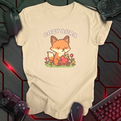 Pixel art fox holding a strawberry with closed eyes, surrounded by flowers and text "Cozy Aura" above, in kawaii cozy gamer style. Soft Cream color t-shirt.