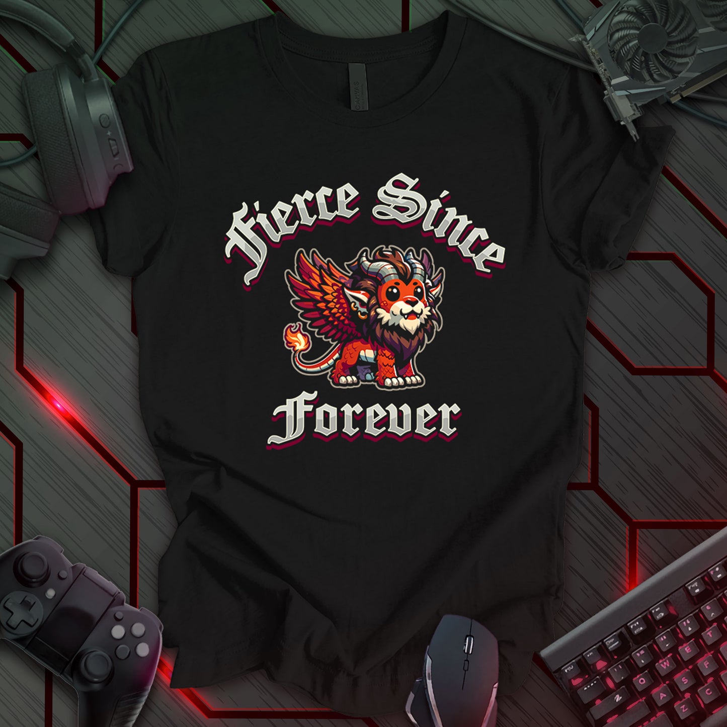 Black gaming t-shirt featuring a Kawaii-style cartoon winged lion with orange and brown coloring, large expressive eyes, horns, a mane, and a flaming tail. Gothic-style fantasy text above and below the lion reads 'Fierce Since Forever' in bold lettering.
