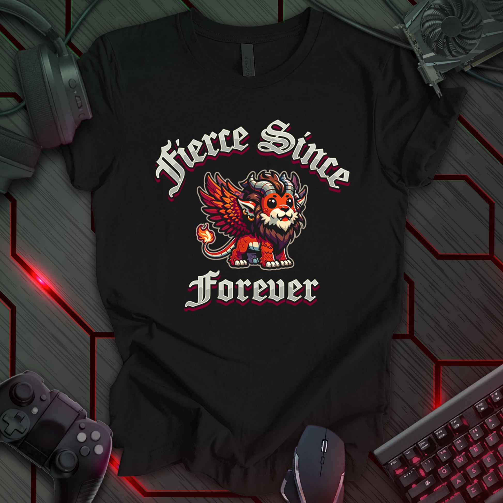 Black gaming t-shirt featuring a Kawaii-style cartoon winged lion with orange and brown coloring, large expressive eyes, horns, a mane, and a flaming tail. Gothic-style fantasy text above and below the lion reads 'Fierce Since Forever' in bold lettering.