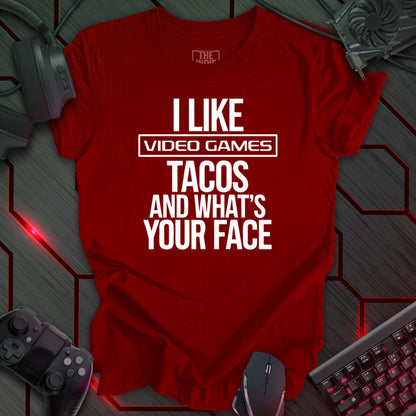 Graphic design featuring the phrase 'I LIKE' in a bold, slightly distressed font at the top, followed by 'VIDEO GAMES' with a rectangle boarder, 'TACOS', and 'AND WHAT'S YOUR FACE' each on separate lines in the same bold, distressed font. All text is white against a cardinal red background. This is a humorous design with an indie gaming and food theme, featuring a playful and quirky sentiment.
