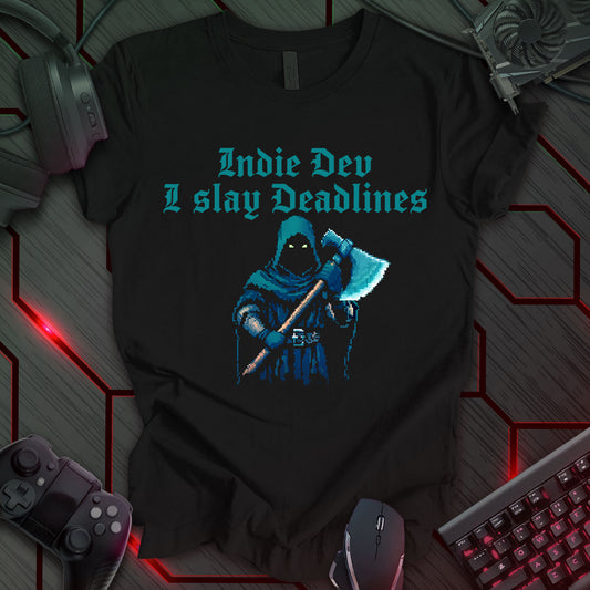 This t-shirt design, targeted at indie game developers, features a pixel art image of a hooded figure with glowing red eyes, holding an axe, on a black background. Above the figure, the text reads 'Indie Dev' and 'I slay Deadlines' in a bold, pixelated font. This design appeals to the determined and often pressured nature of independent game development.