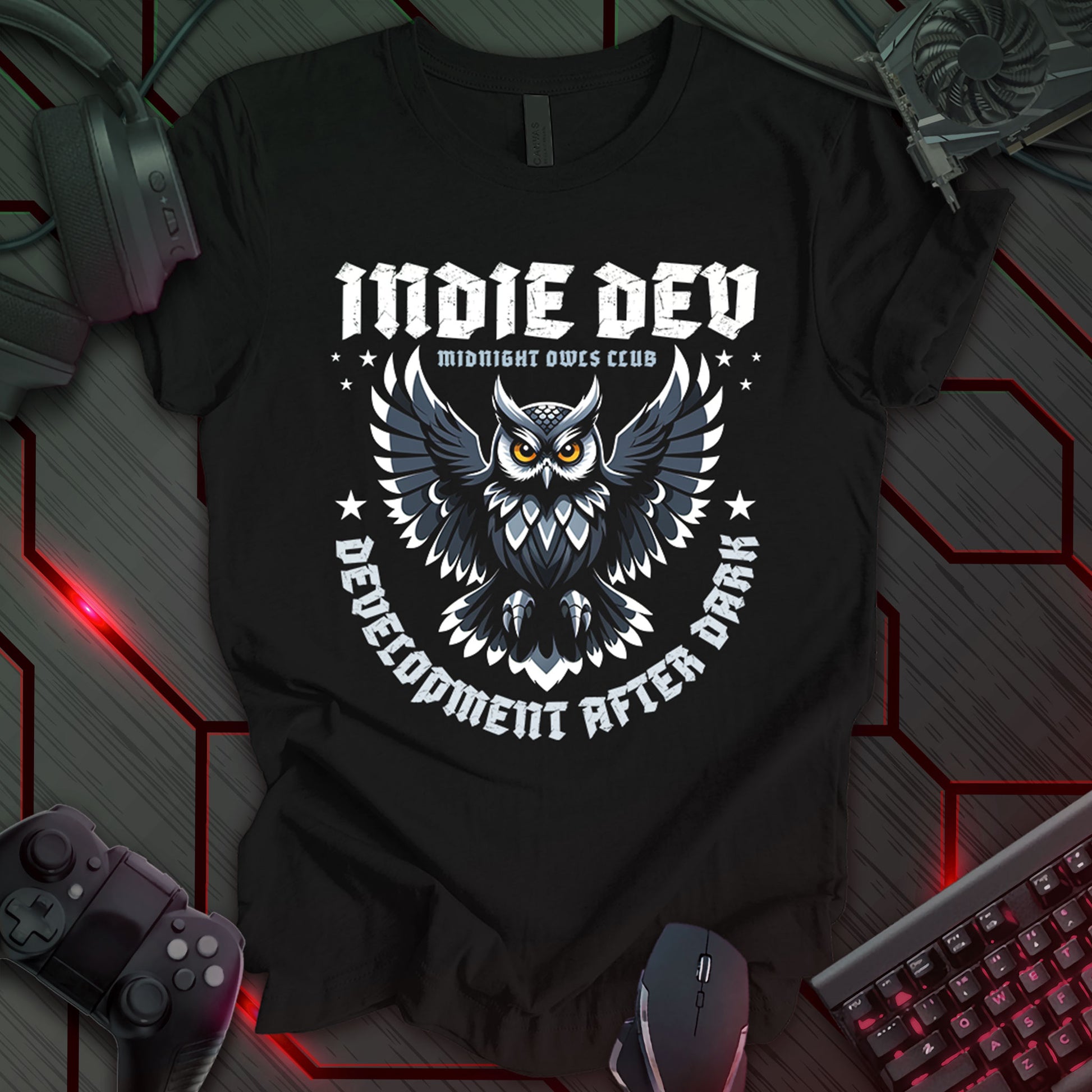 This t-shirt design, created for indie game developers, features the text 'INDIE DEV' in a bold, stylized font at the top, followed by 'MIDNIGHT OWLS CLUB' in smaller text. A central graphic of a detailed owl with outstretched wings is surrounded by the curved text 'DEVELOPMENT AFTER DARK'. This design appeals to developers who work late hours and are part of the independent game development community.