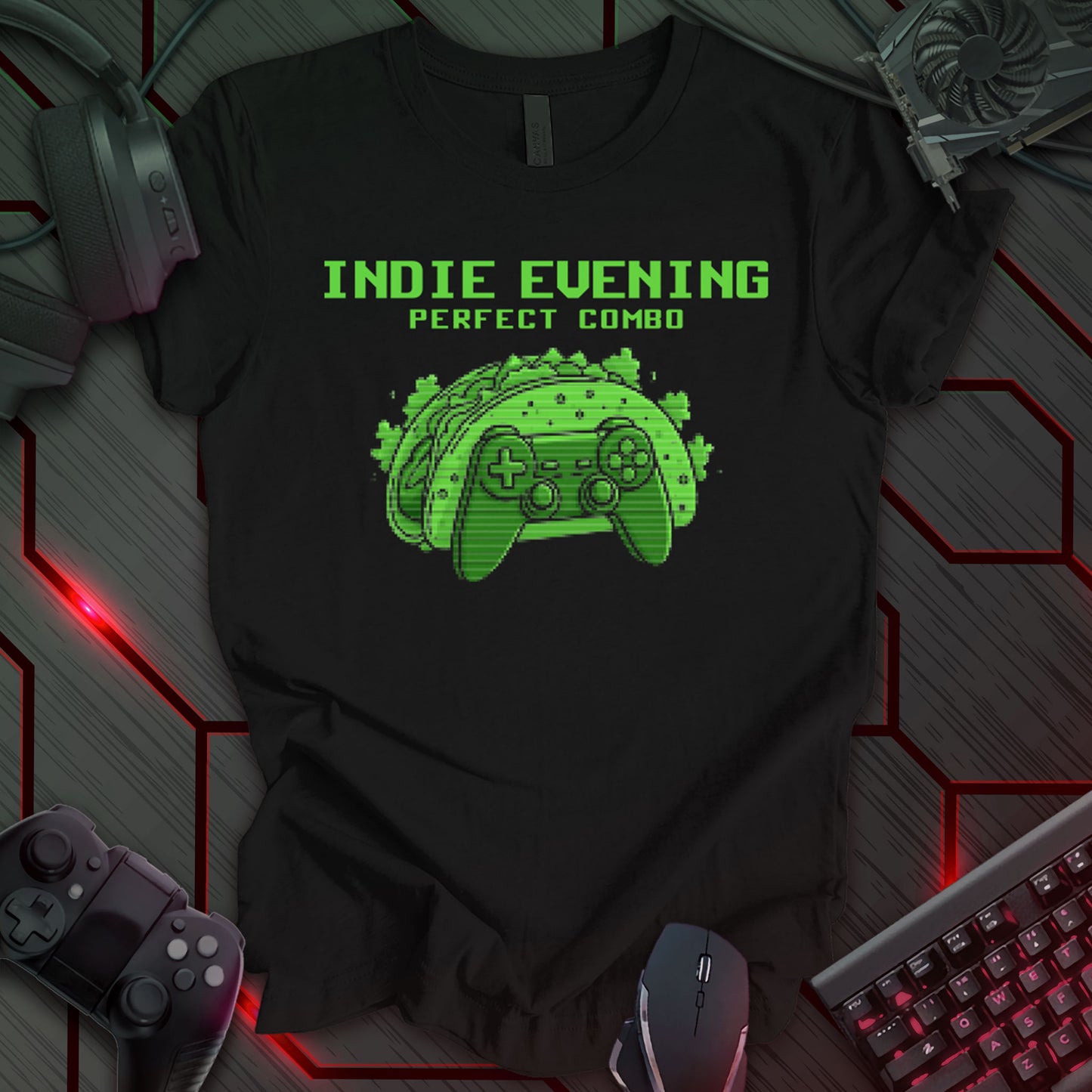 This t-shirt design, created for indie game developers, features the phrase 'INDIE EVENING PERFECT COMBO' in a pixelated font at the top. Below, a pixel art image of a taco shell shaped like a game controller is displayed in shades of green on a black background. This design humorously depicts a relatable evening for those in the independent game development community.