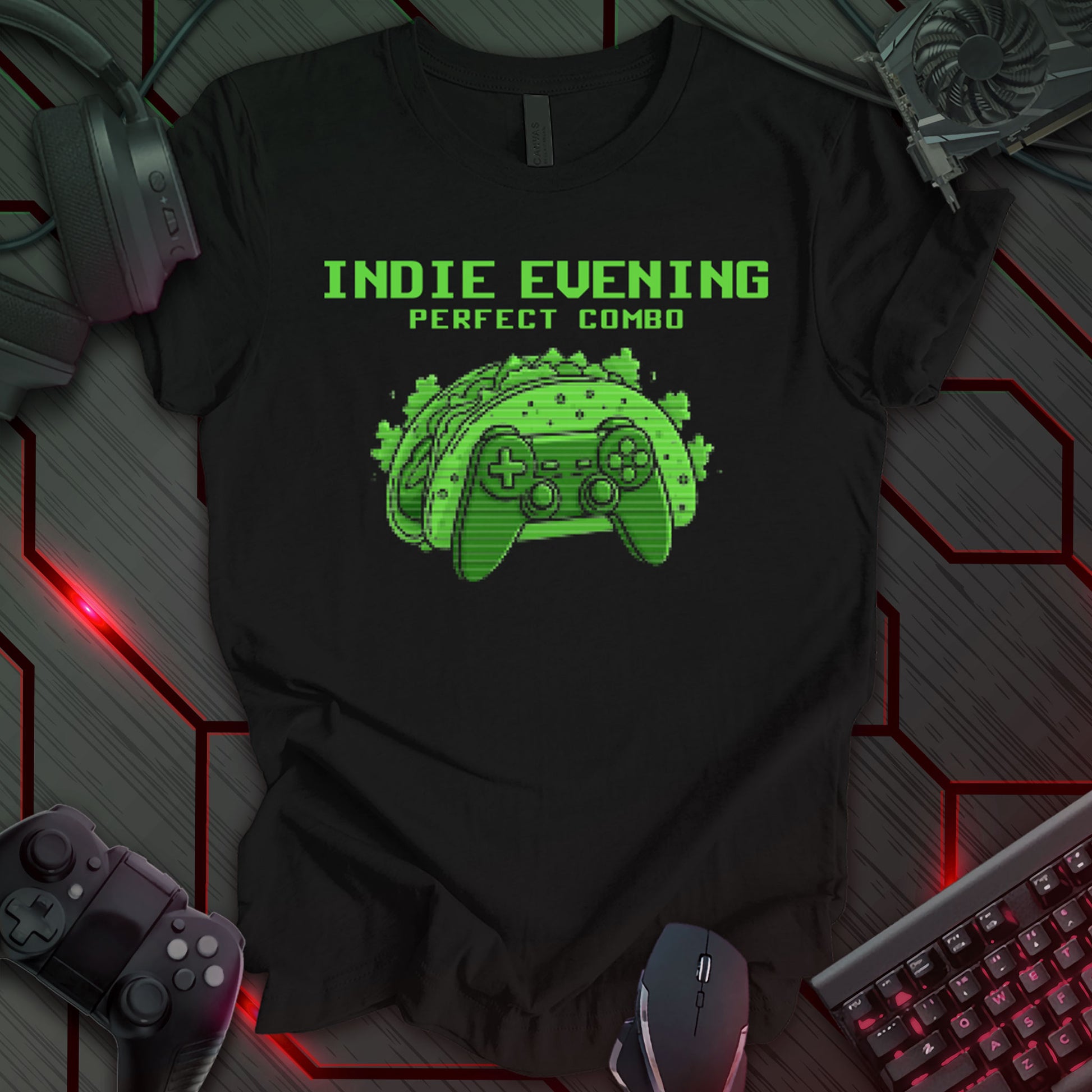 This t-shirt design, created for indie game developers, features the phrase 'INDIE EVENING PERFECT COMBO' in a pixelated font at the top. Below, a pixel art image of a taco shell shaped like a game controller is displayed in shades of green on a black background. This design humorously depicts a relatable evening for those in the independent game development community.