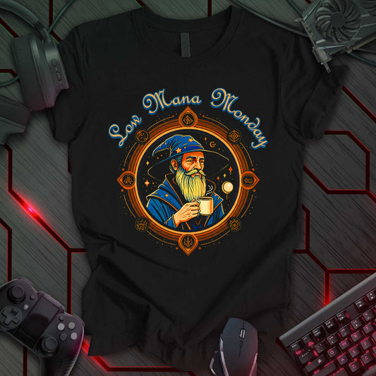 Graphic design featuring the text 'Mana Monday' above the word 'Low', both rendered in a bold, stylized font with a distressed texture. The text is displayed in a dark color against a light background. This is a 'Low Mana Monday' themed design, likely related to gaming or fantasy concepts.