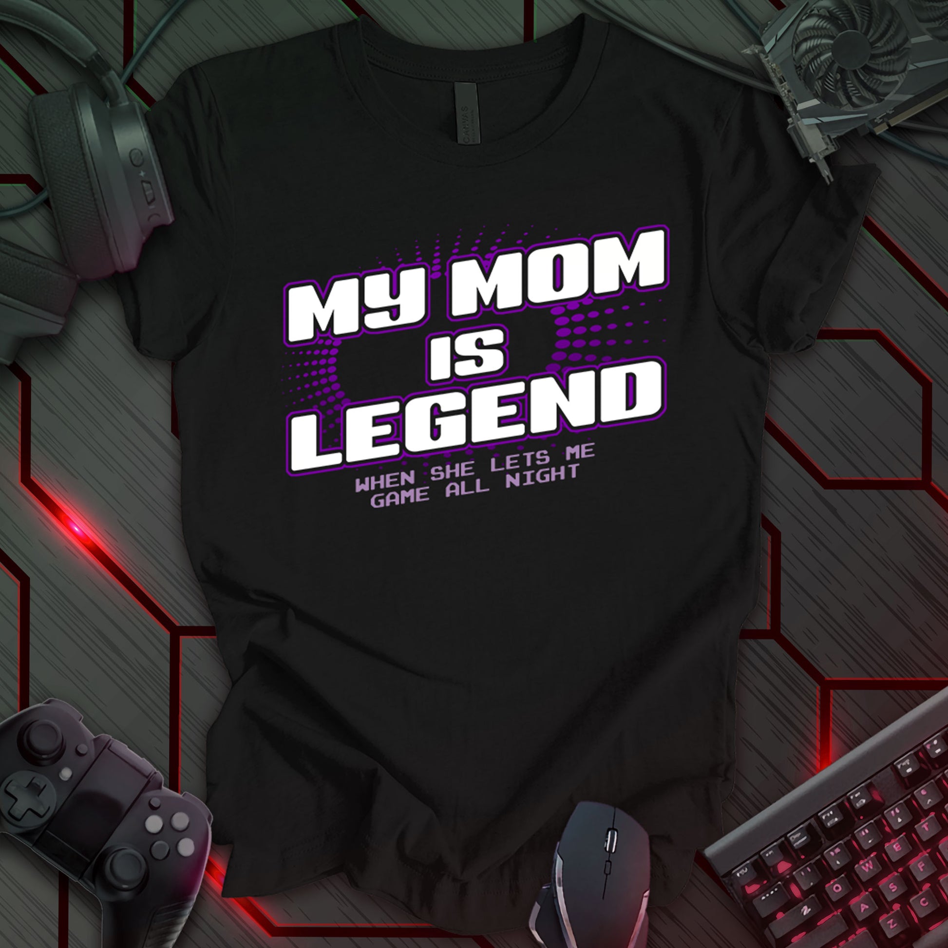 T-shirt design with bold white text "MY MOM IS LEGEND" on a black background, accented with purple dots and lines. Includes "WHEN SHE LETS ME GAME ALL NIGHT" below. Humorous and celebratory design for gaming moms. Ideal for gifts. Keywords: gamer mom shirt, funny kid tee, video game t-shirt, legendary mom gift, gaming humor, teen gamer gift, mom appreciation shirt, gaming family apparel.