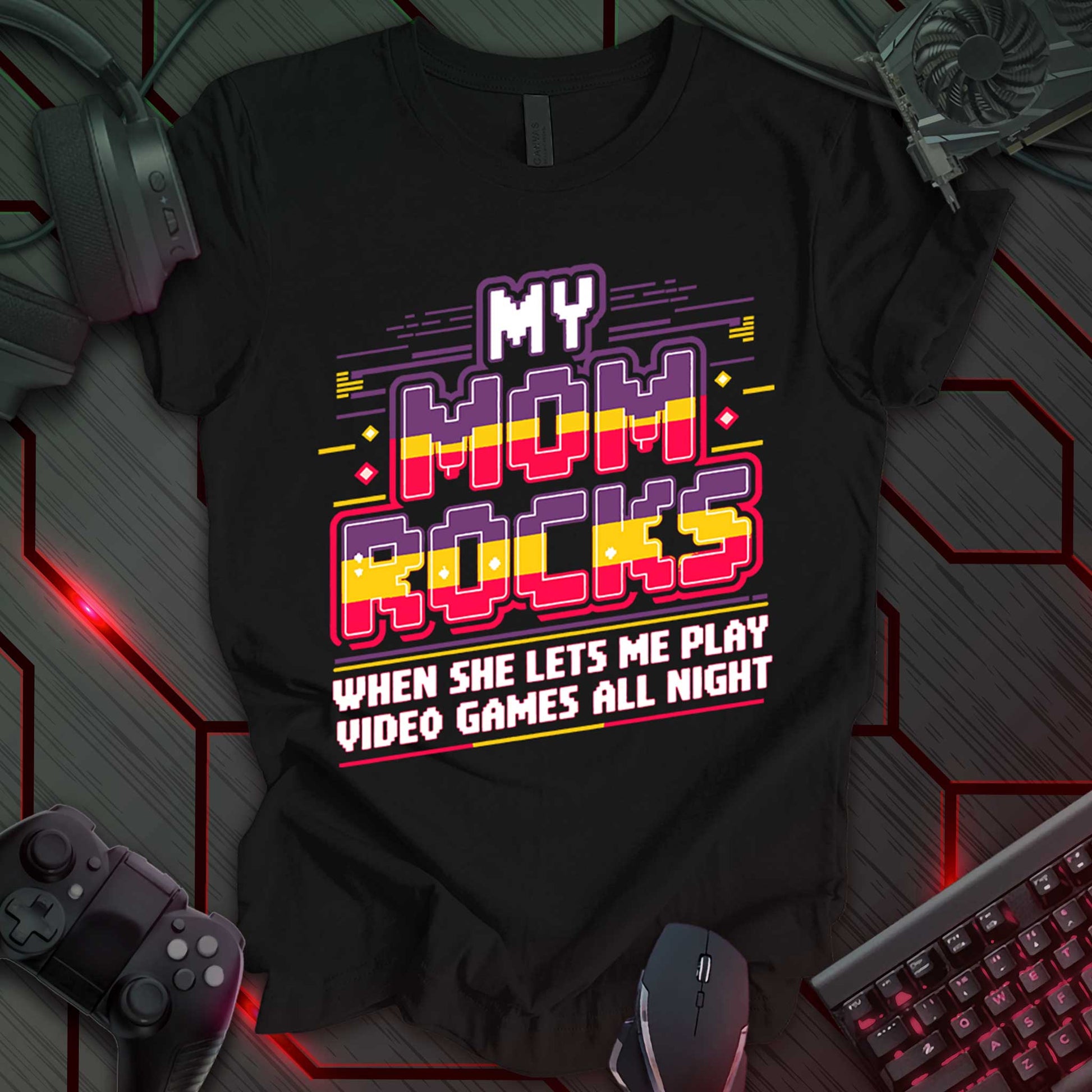 This t-shirt design, targeted at young gamers, features the phrase 'MY MOM ROCKS WHEN SHE LETS ME PLAY VIDEO GAMES ALL NIGHT' in a bold, pixelated font with red, yellow, and black colors. The design includes stylized lines and geometric shapes, appealing to a playful, video game-loving audience.