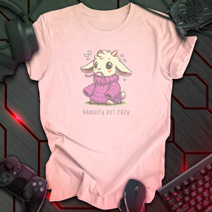 Pixel art goat in oversized purple sweater with “Naughty But Cozy” text underneath. Soft pink background.