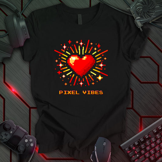 Black T-shirt featuring a pixel-art design of a vibrant red heart with radiant red and yellow energy lines. Below the heart, 'PIXEL VIBES' is written in a retro pixel-style gradient font. Perfect for gamers, retro gaming fans, and lovers of nostalgic 8-bit aesthetics.