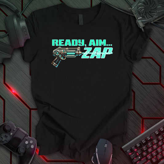 Black T-shirt featuring a pixel-art design of a metallic sci-fi ray gun firing a light blue energy blast. The futuristic text reads 'Ready, Aim... Zap' in a bold, retro-style font. Perfect for sci-fi fans, retro gaming enthusiasts, and lovers of classic space adventure themes.