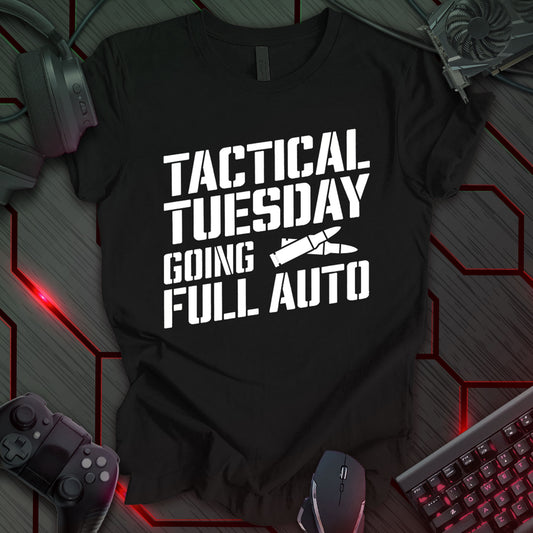 Graphic design featuring the phrase 'TACTICAL TUESDAY' in a bold, stencil-style font at the top, followed by 'GOING' and 'FULL AUTO' in the same font. Between 'TUESDAY' and 'GOING' is an illustration of a bullet. All text and the bullet illustration are white against a black background. This is a design with a tactical or military theme, featuring a bold statement and a bullet image.